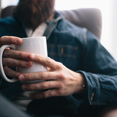 a guy holding coffee mug